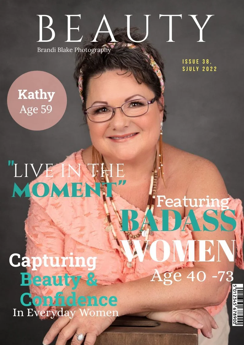 Magazine cover featuring a smiling middle-aged woman with short dark hair, glasses, wearing a pink textured top and layered necklaces, against a gray background with text overlay about celebrating women.