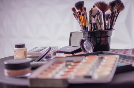 Makeup brushes and cosmetics on a table.